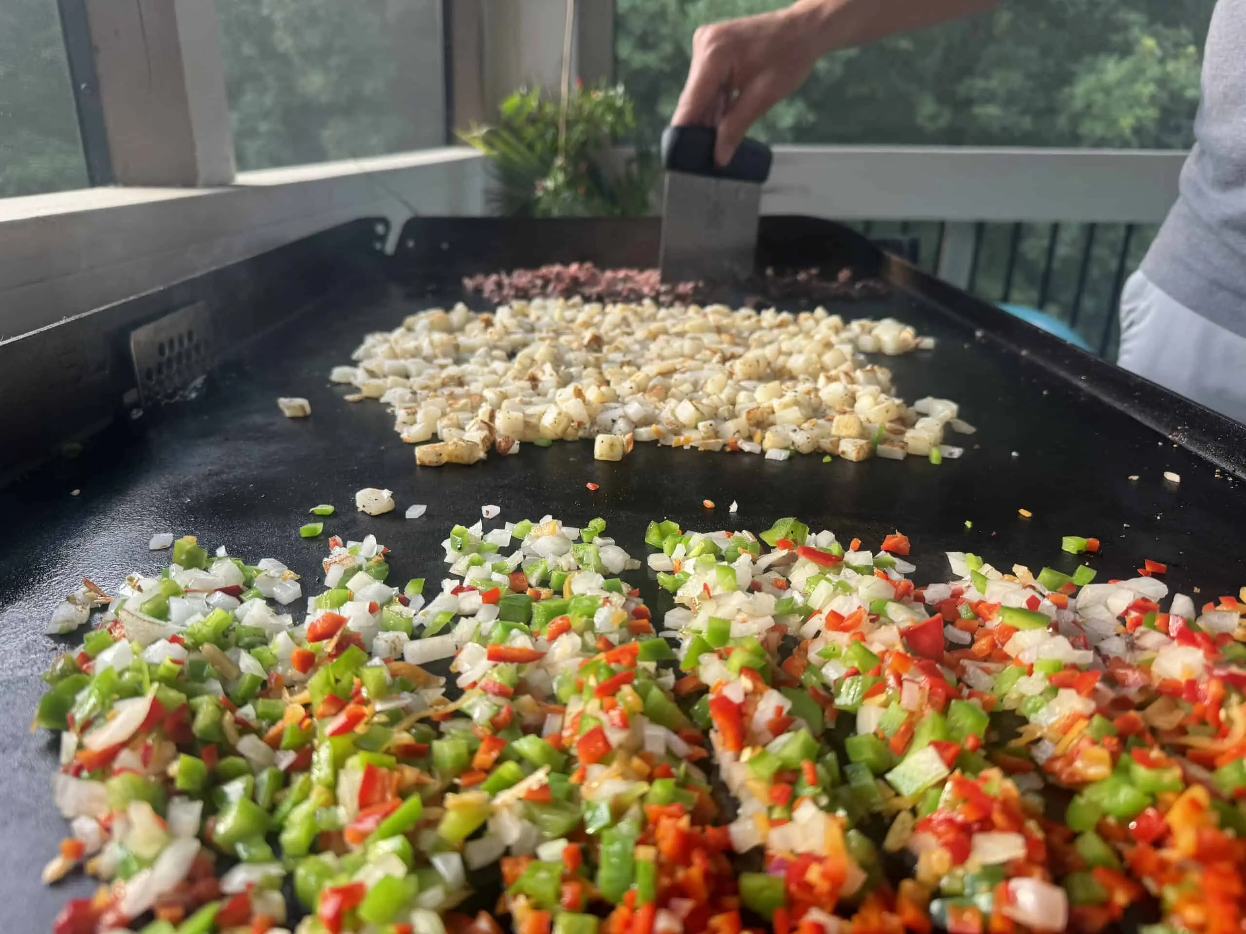 Cooking vegetables on a flat-top outside